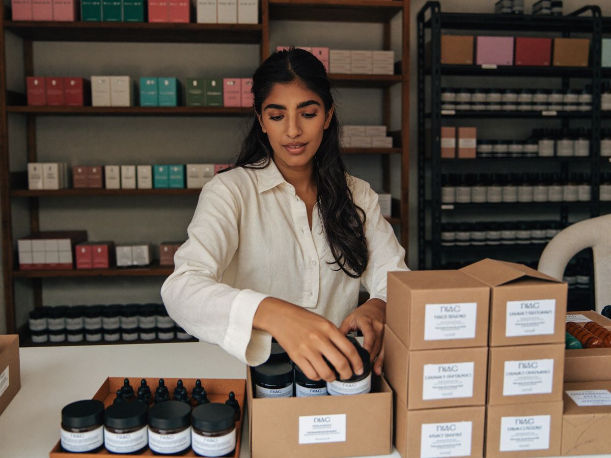A founder packing products in her studio